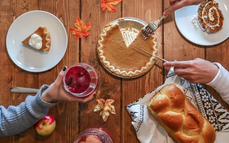 person slicing pie beside bread — Photo by Element5 Digital on Unsplash