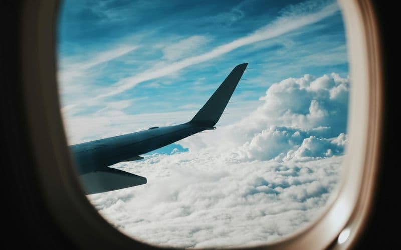 person taking picture of plane wings while flying during daytime — Photo by Blake Guidry on Unsplash