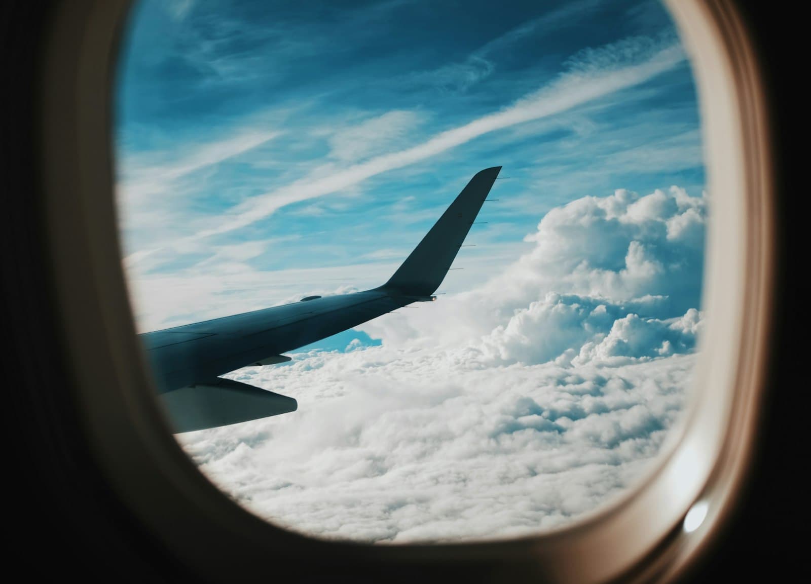 person taking picture of plane wings while flying during daytime — Photo by Blake Guidry on Unsplash