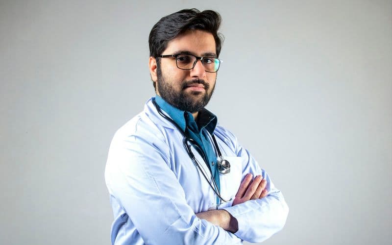 man in white dress shirt wearing black framed eyeglasses — Photo by Usman Yousaf on Unsplash