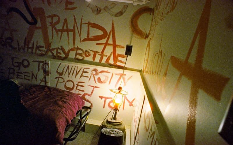 Wall covered in orange graffiti and writing — Photo by Austin on Unsplash