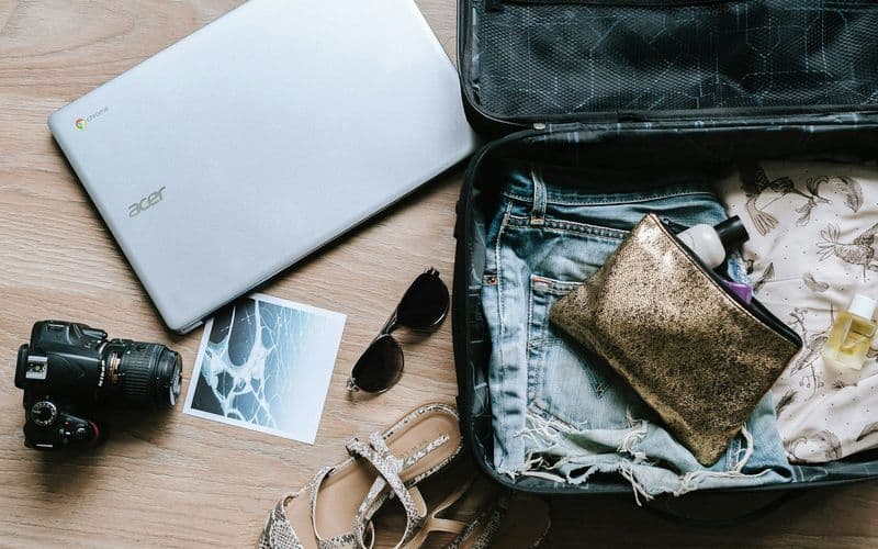 black DSLR camera near sunglasses and bag — Photo by Anete Lūsiņa on Unsplash