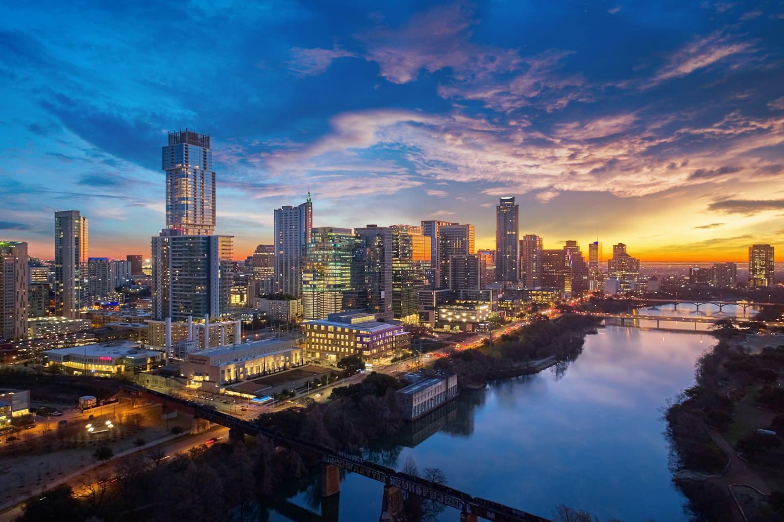 a city skyline at sunset — Photo by Justin Wallace on Unsplash