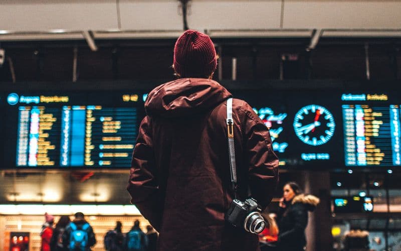 person looking up to the flight schedules — Photo by Erik Odiin on Unsplash