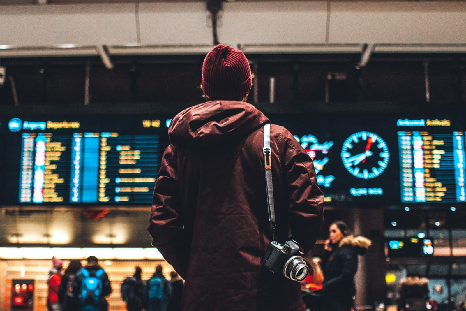 person looking up to the flight schedules — Photo by Erik Odiin on Unsplash